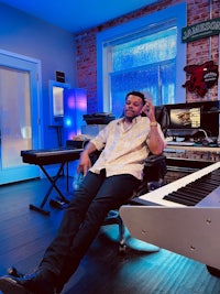 a man sitting in a chair in a recording studio