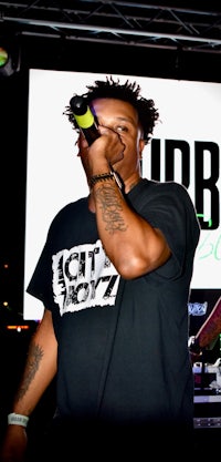 a man holding a microphone in front of a stage